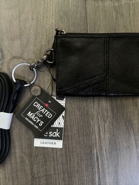 The Sak Black Leather Zip card holder with lanyard with Teal Interior